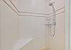 The en-suite primary bathroom offers dual sinks, a soaking tub and spacious shower with built-in bench