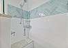 A spacious shower with built-in bench in the en-suite guest bathroom