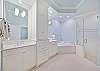 The en-suite primary bathroom offers dual sinks, a soaking tub and spacious shower