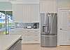 The fully equipped kitchen offers lake view and sliding doors opening up to the screened in lanai