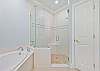 The en-suite primary bathroom offers dual sinks, a soaking tub and spacious shower