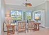 Living area with sliding doors opening up to the screened in lanai