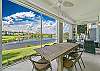 Oversized lanai with dining and seating areas and stunning lake view