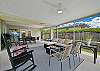 The large screened and covered lanai offers a dining area with TV and BBQ, and a seating area