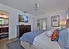 Primary bedroom with king size bed and smart TV