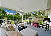 The large screened and covered lanai offers a dining area with TV and BBQ, and a seating area