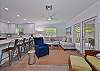 Living with comfortable seating and large smart TV. French doors open up to the large screened and covered lanai