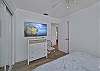 A king bed and smart TV in the guest bedroom