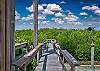 Enjoy amazing sunsets over the bay from the large porch or dock (right side, the walkway to the dock is shared with neighbor). 