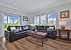 The living offers comfortable seating a smart TV and stunning bay view