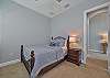 A queen bed in the third bedroom