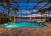 Peaceful evening view to the lighted pool and fountain