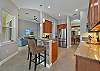 Fully equipped kitchen with breakfast bar and breakfast nook overlooking the pool area and lake