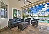Covered seating area with TV, overlooking the private heated pool and spa with gorgeous lake view