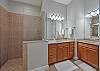 The en-suite bath features dual sinks, a relaxing garden tub, and a separate shower. 