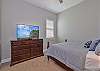 A queen bed in the third bedroom