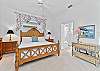 A king bed and smart TV with cable in the primary bedroom. Sliding doors open up to the screened in lanai