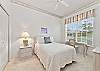 The guest bedroom is equipped with a full size bed and a desk