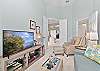 The den is set up as a family room with a pull-out couch and smart TV with cable