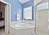 Dual sinks a soaking tub and shower in the en-suite primary bathroom