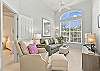 The den is set up as a family room with a pull-out couch and smart TV with cable