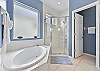 Dual sinks a soaking tub and shower in the en-suite primary bathroom