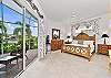 A king bed and smart TV with cable in the primary bedroom. Sliding doors open up to the screened in lanai
