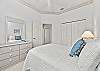 The guest bedroom is equipped with a full size bed and a desk