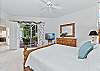 A king bed and smart TV with cable in the primary bedroom. Sliding doors open up to the screened in lanai