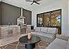 Under the covered lanai, you’ll find comfortable lounge seating with ceiling fans and a full outdoor kitchen with a stainless grill, sink, beverage fridge and vent hood, ready for poolside dinners.