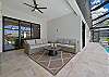 Under the covered lanai, you’ll find comfortable lounge seating with ceiling fans and a full outdoor kitchen with a stainless grill, sink, beverage fridge and vent hood, ready for poolside dinners.