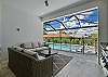 Under the covered lanai, you’ll find comfortable lounge seating with ceiling fans and a full outdoor kitchen with a stainless grill, sink, beverage fridge and vent hood, ready for poolside dinners.
