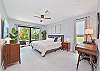The primary bedroom features a king size bed, smart TV, office nook and it's own patio!