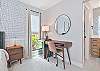 The primary bedroom features a king size bed, smart TV, office nook and it's own patio!