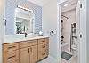 The bathroom with a shower-tub combo