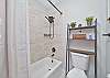 The bathroom with a shower-tub combo