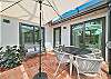 Large, screened in patio with seating and dining area