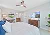 The primary bedroom features a king size bed, smart TV, office nook and sliding doors to the patio