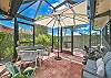 Large, screened in patio with seating and dining area