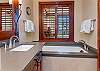 Dual sink vanity and deep soaking tub
