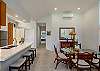 Dining area with glass table and breakfast bar seating