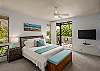 Master bedroom with balcony access and flatscreen TV