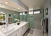 Spacious bathroom with double vanity and glass shower