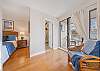 Bright and airy bedroom with a sitting area and sliding doors to a private outdoor space.