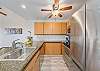 Modern kitchen with wood cabinets, granite countertops, and stainless appliances.
