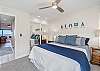 Bright and airy bedroom featuring a king bed and island-inspired touches.