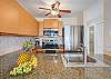 Modern kitchen with granite island, stainless appliances and ceiling fan