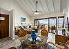 Open living-dining area with vaulted ceilings and ocean-view lanai.