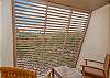 Private lanai with stylish slatted panels and tropical views.