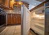 Well-equipped kitchen includes a built-in fridge and freezer.